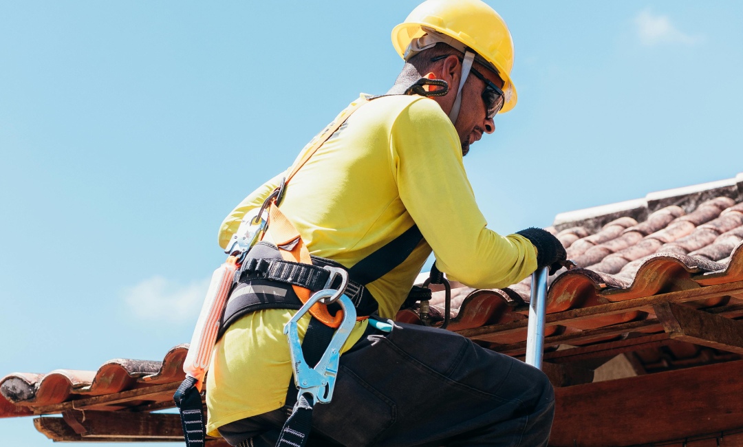 Contractor inspecting gutter granule buildup as part of a fall roof maintenance checklist South Carolina