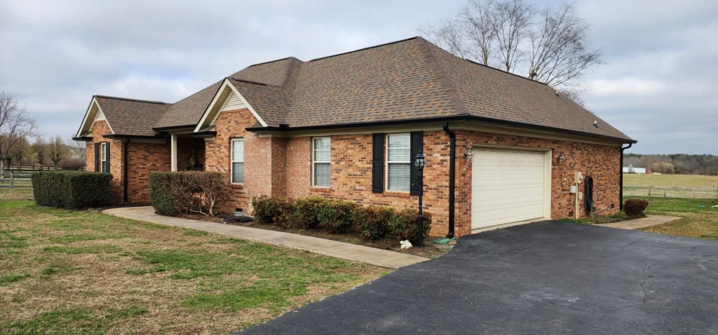 Shingle roofing on a brick home in Spartanburg SC showing a newly installed architectural shingle roof with clean edges and proper ventilation.