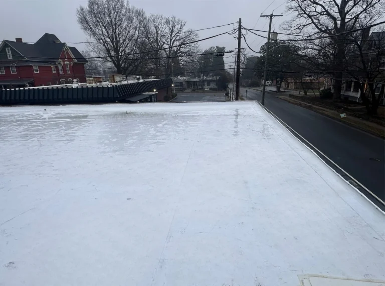 Commercial flat roof installation in Spartanburg SC with new white membrane system