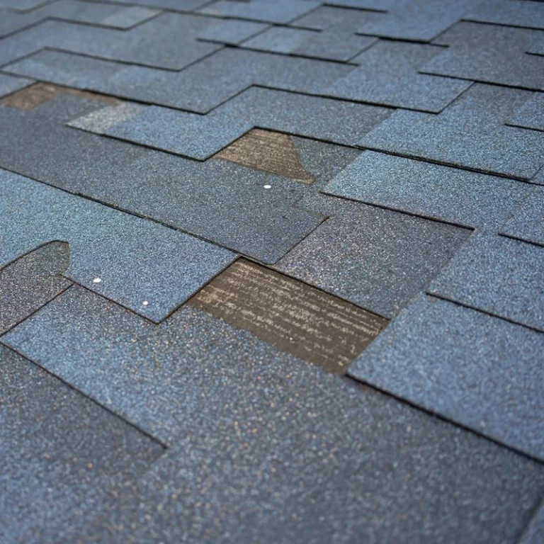 Emergency roof repair on Spartanburg home showing damaged asphalt shingles and exposed underlayment