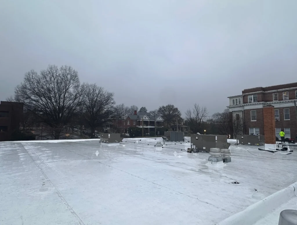 Commercial flat roof repair South Carolina on a large warehouse building with TPO membrane visible